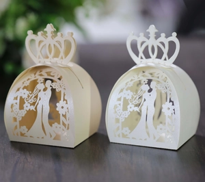 Detail of laser-cut crown candy box showing bride and groom silhouette and pearl finish