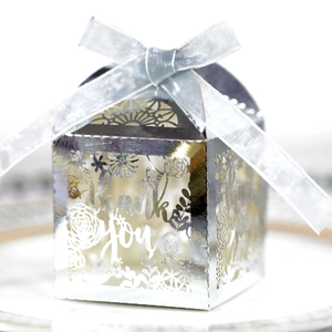 Detail of silver laser-cut gift box featuring hollowed Thank You text and ribbon