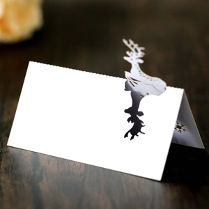 Laser cut white reindeer and snowflake place cards for Christmas table decorations