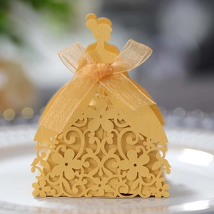 Close-up of laser-cut wedding candy box with golden female silhouette and ribbon bow