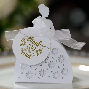 Detail of laser-cut bridal silhouette candy box with white ribbon and Thank You tag