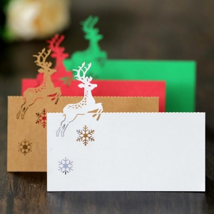 Close-up of laser-cut reindeer and snowflake designs on colorful Christmas place cards