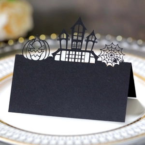 Detailed laser-cut Halloween place card with pumpkin and castle design on table setting