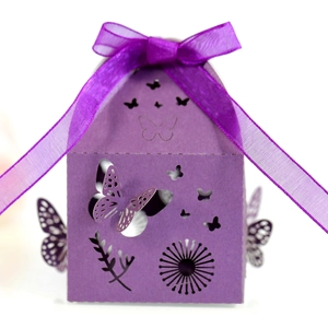 Detail of laser-cut butterfly gift box in deep purple cardstock with satin ribbon bow