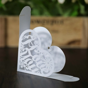Macro shot of white pearlescent heart-shaped candy box with laser-cut Love You design