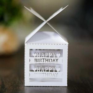 Close-up of white Happy Birthday gift box with heart镂空 design and pearlescent texture