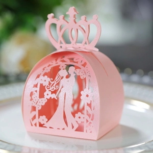 Detailed laser-cut pink wedding favor box with bride groom silhouette and crown lid