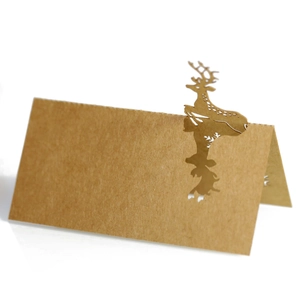 Detail of laser-cut reindeer on brown kraft paper place cards for festive tables