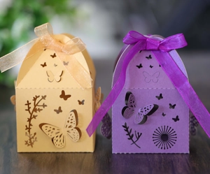 Detail of laser-cut butterfly gift boxes with decorative organza ribbons and floral patterns