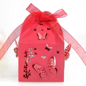 Detail of red laser-cut butterfly gift box with delicate organza ribbon bow for weddings