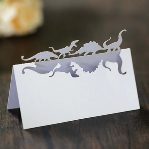 Détail des marque-places dinosaures découpés au laser en papier blanc pour les fêtes