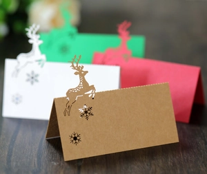 Detail of laser-cut reindeer and snowflake hollow designs on colorful festive place cards