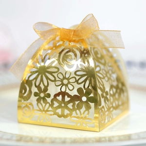 Detailed laser-cut floral candy box in gold finish with an elegant organza ribbon bow