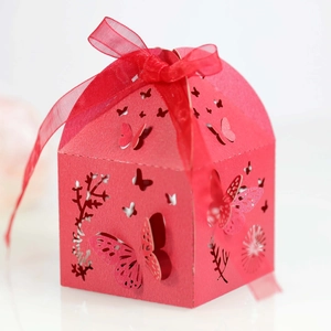 Detailed laser-cut hollow butterfly pattern on red house-shaped candy gift box