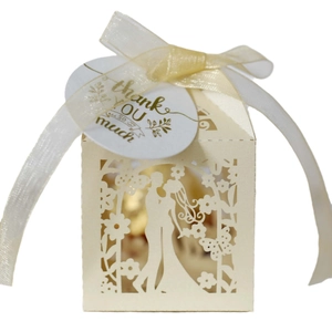 Laser-cut wedding favor box with romantic silhouette, ribbon bow and thank you tag