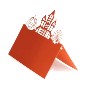 Close-up of 3D cutout Halloween place card with haunted castle and pumpkin motifs