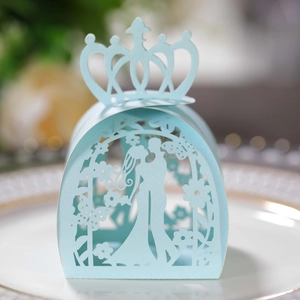 Detail of light blue laser-cut candy box with crown top and romantic couple silhouette
