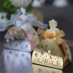 Laser-cut bridal gown candy boxes in gold and silver with elegant ribbon bow detailing