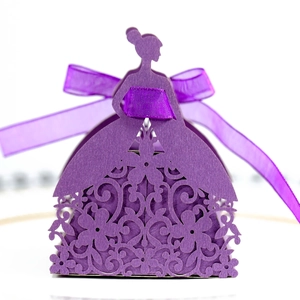 Close-up of laser-cut floral patterns on a purple dress-shaped wedding gift box