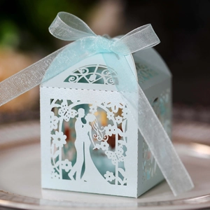 Laser-cut light blue wedding candy box featuring a bride and groom hollow design with silk ribbon