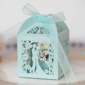 Detailed laser-cut wedding favor box in mint blue with ribbon and bride groom silhouette