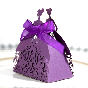Detail of laser-cut purple gift box with bridal dress design and satin ribbon bow