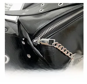 Close-up of black wrinkled leather texture and smooth silver metal zipper on tote bag