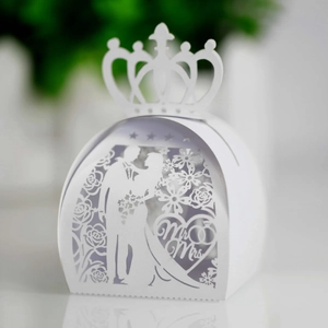 Macro detail of laser-cut wedding favor box with Mr & Mrs silhouette and crown