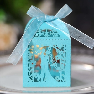 Detail of light blue laser-cut wedding favor box with bride and groom silhouette