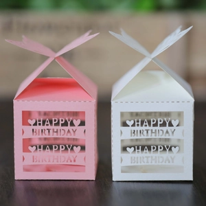 Detailed view of laser-cut pink and white Happy Birthday gift boxes with butterfly tops