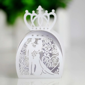 Detailed laser-cut white wedding favor box with a crown top and Mr & Mrs heart pattern