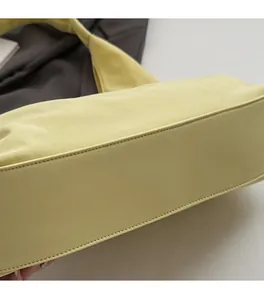 Close-up of precise stitching on yellow leather tote bag showing high-quality craftsmanship