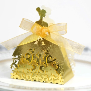 Detail of laser-cut princess candy box in gold pearlescent paper with ribbon bow