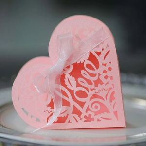 Detailed laser-cut pink heart favor box with floral patterns and LOVE lettering detail