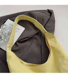 Close-up of minimalist pale yellow tote bag with comfortable and wide shoulder strap