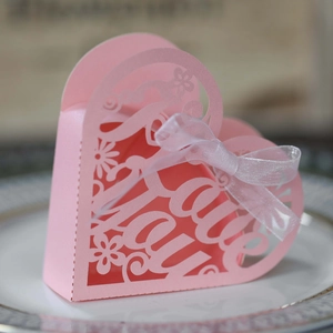 Pink heart-shaped laser-cut gift box with I Love You text and white ribbon detail