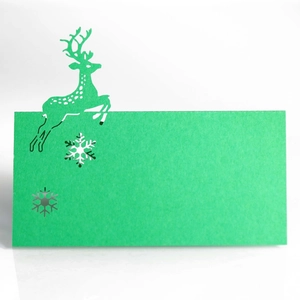 Detailed laser-cut green Christmas reindeer place card with delicate snowflake cutouts