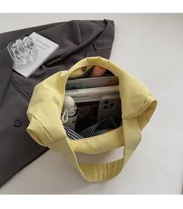 Spacious interior of a yellow canvas tote bag showing storage for daily essentials