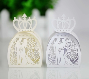 Macro detail of laser cut bride and groom silhouette wedding favor gift box with crown top