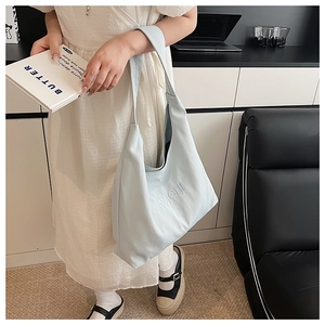 Detailed embroidery of MYICHI lettering on a soft light blue canvas tote bag