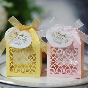 Detailed laser-cut paper gift boxes with heart patterns, ribbons, and thank you tags