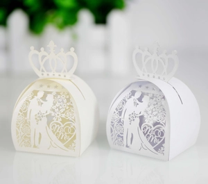 Macro view of laser-cut Mr & Mrs wedding candy boxes with intricate crown top detail