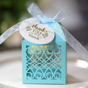 Close-up of light blue laser-cut wedding gift box with ribbon and Thank You tag