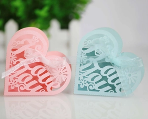 Detail of laser-cut heart candy boxes in pink and blue with Love You hollow pattern