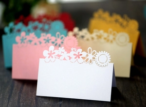 Detailed laser cut sunflower table seating cards in white, pink, beige and blue colors