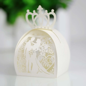 Detailed laser-cut white wedding favor box featuring Mr & Mrs heart and floral hollow patterns