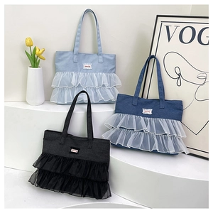 Detailed view of denim tote bags with elegant lace ruffles and Fashion Bag patch