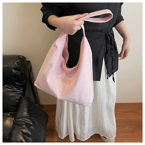 Detailed shot of large pink tote bag with MVICHI logo and comfortable wide shoulder strap