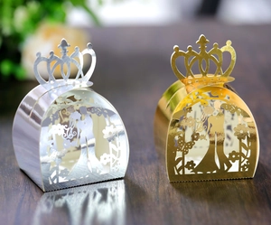 Detail of laser-cut gold and silver crown candy boxes with bride and groom silhouette