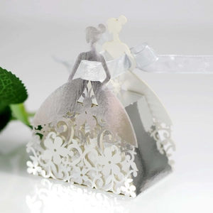 Detailed laser-cut silver wedding favor box with bride silhouette and white ribbon bow